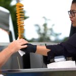 Woman serving twisted spuds at the Thorpdale Potato Festival